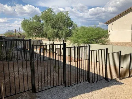 Black wrought iron fence in residential setting, ideal for level terrain, introducing different fencing methods for various landscapes