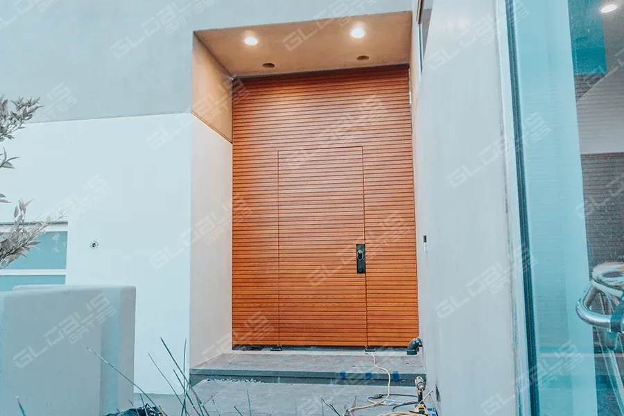 Modern exterior door flanked by stylish wooden wall panels