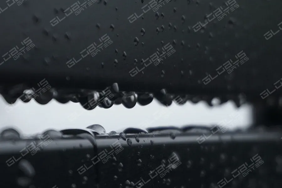 Close-up of rain droplets on a durable fence enduring salt, sand, and spray in coastal weather conditions