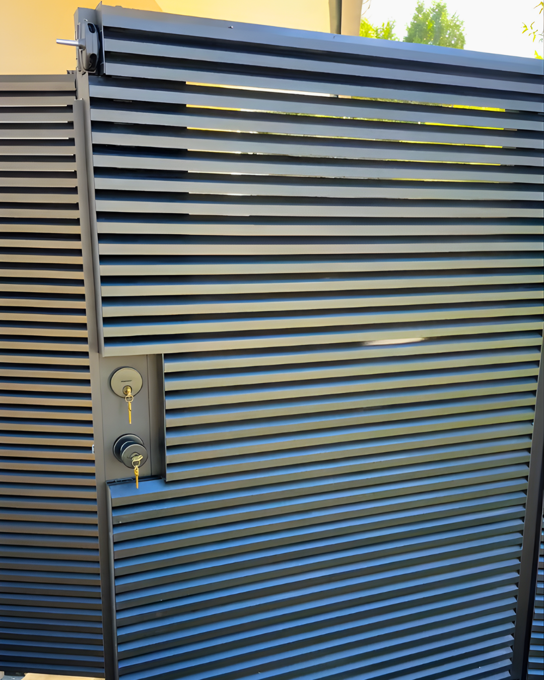 AeroLouver aluminum gate with angled louver slats for privacy and airflow at garden entrance