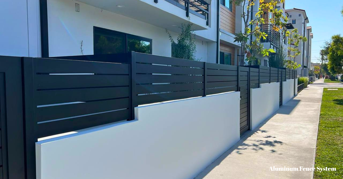 Aluminum wall topper fence panel mounted on brick wall for added garden security