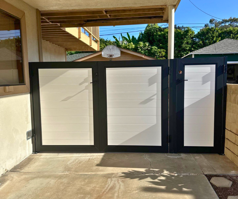 Aluminum framed vinyl gate installed at residential property for weather-resistant boundary