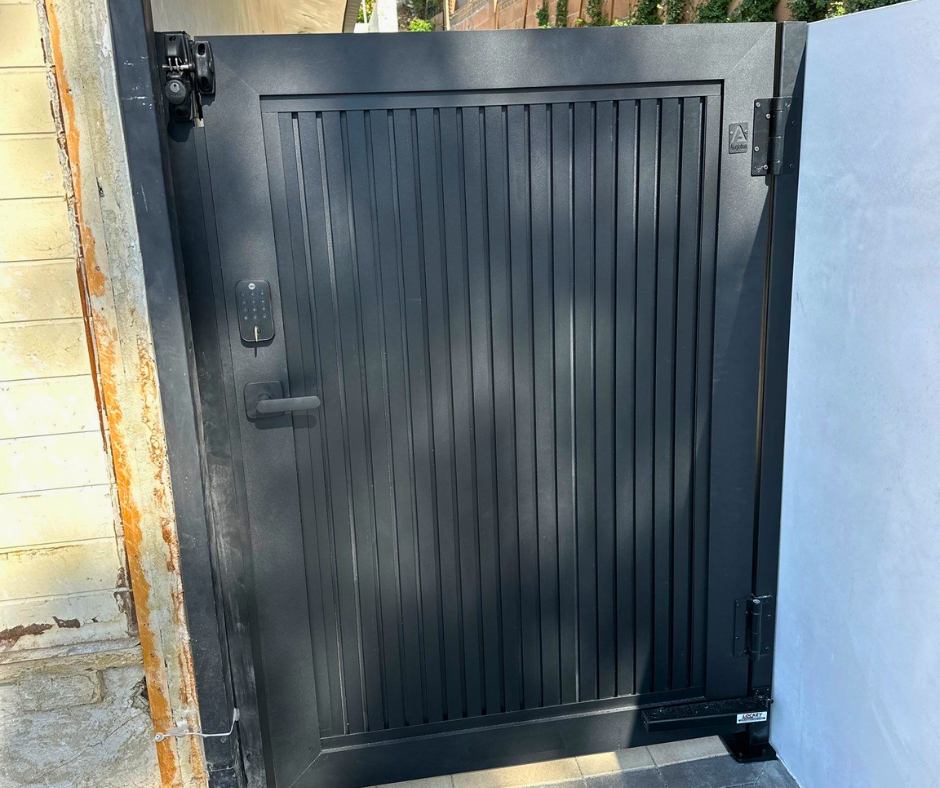 Flush aluminum cladding gate with seamless panel surface for contemporary home exterior