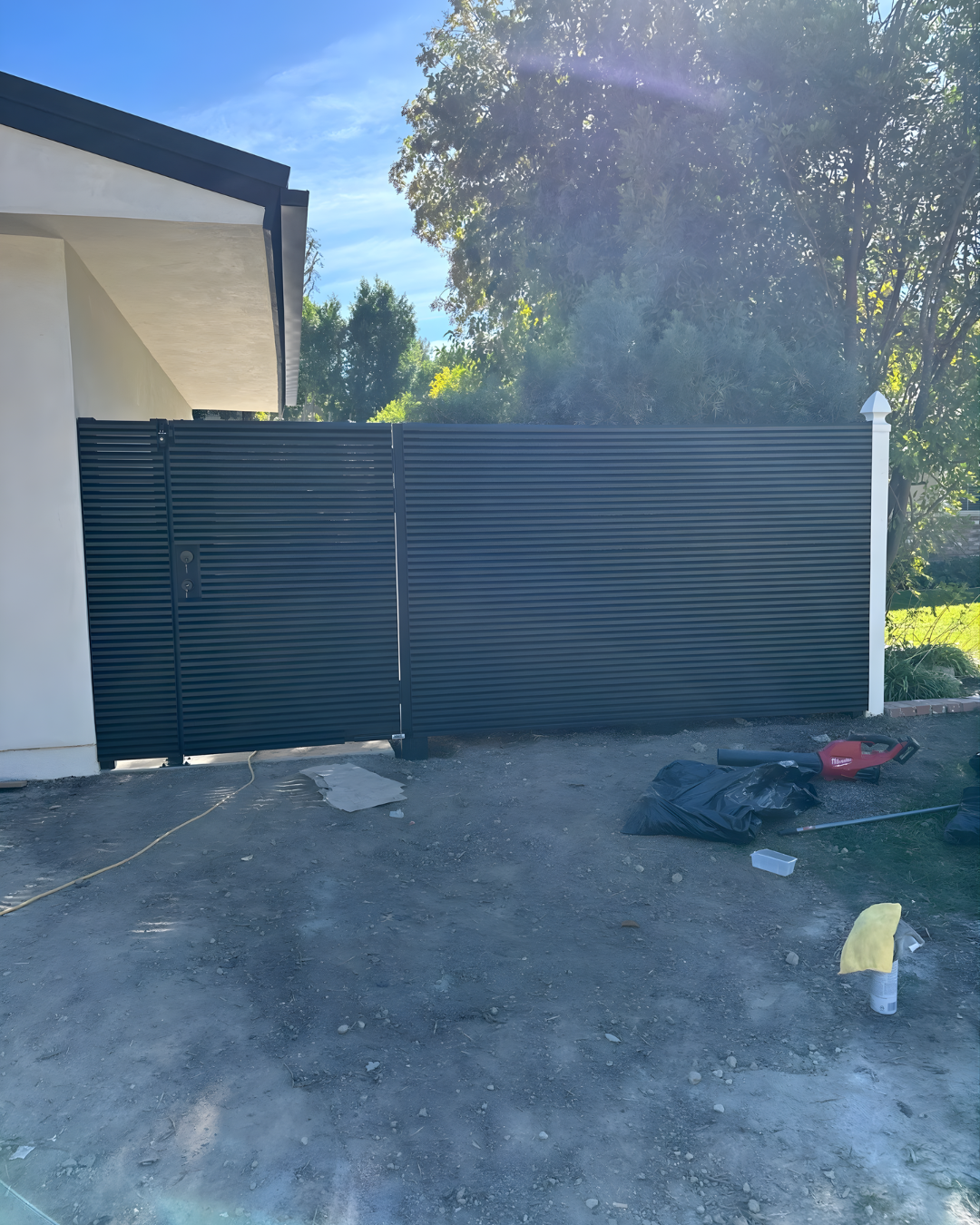 Front view of AeroLouver aluminum gate with modern louvered design for full privacy