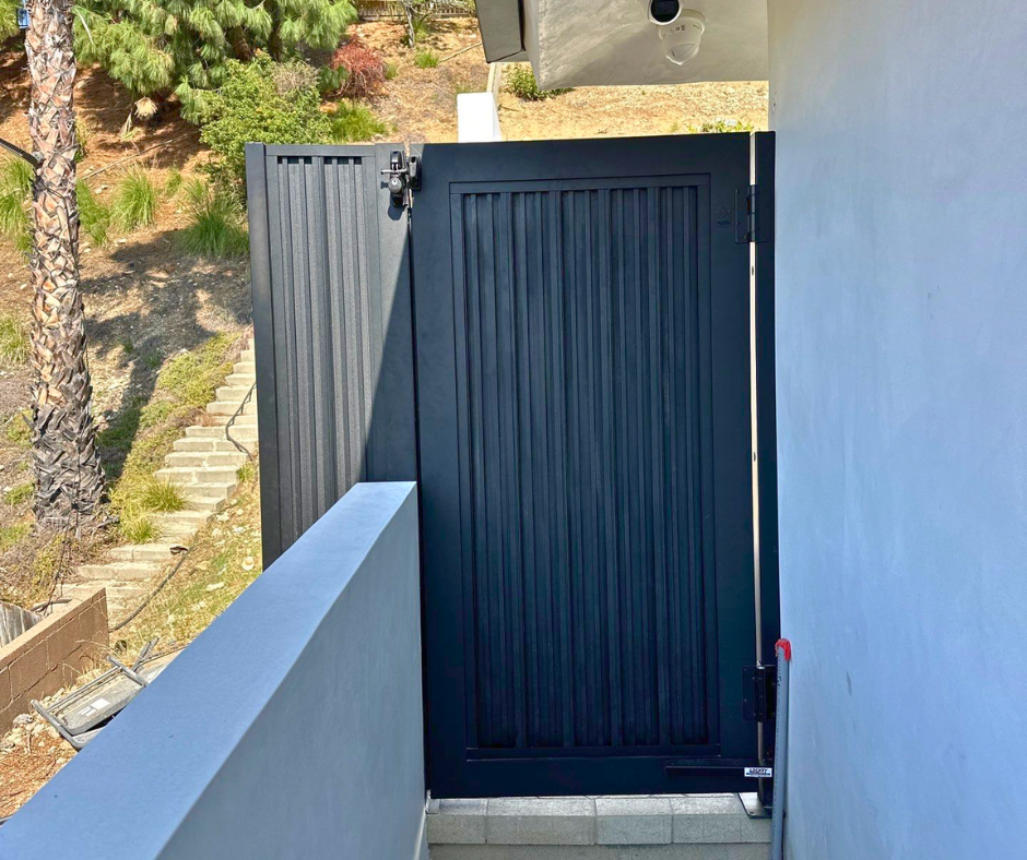 Aluminum cladding gate installed at residential entrance matching boundary wall system