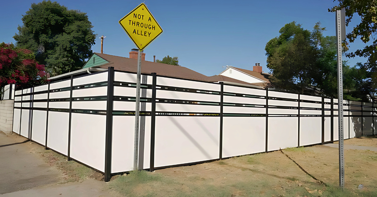 Vinyl privacy fence installed along modern home exterior with clean finish