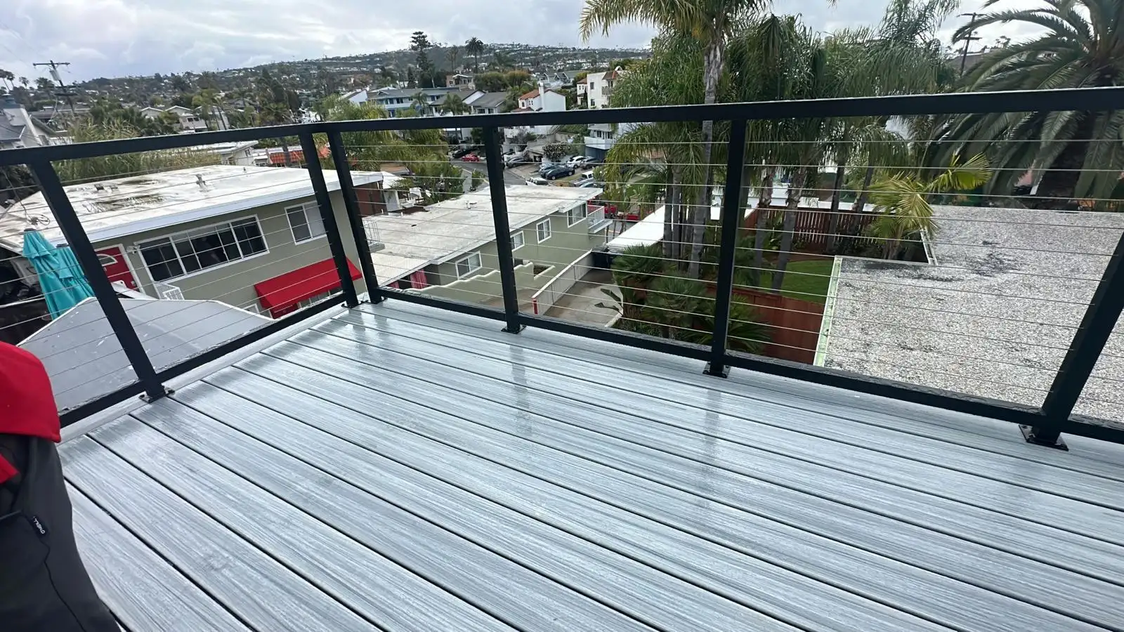 Cable railing installed around rooftop deck
